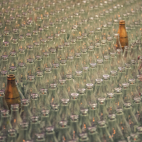 large quantities of clear glass whiskey bottles