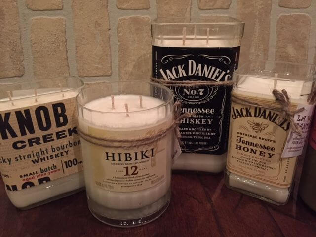 decorated glass whiskey bottle with wax