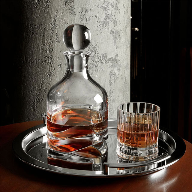transparent glass whiskey bottle and glass cup